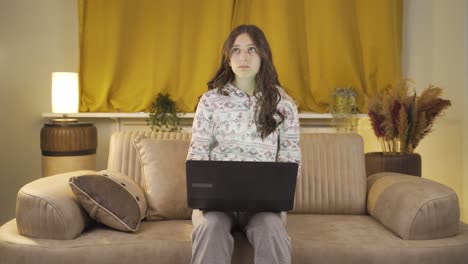 Unhappy-young-woman-using-laptop-laptop-at-night.-It's-not-in-a-good-mood.